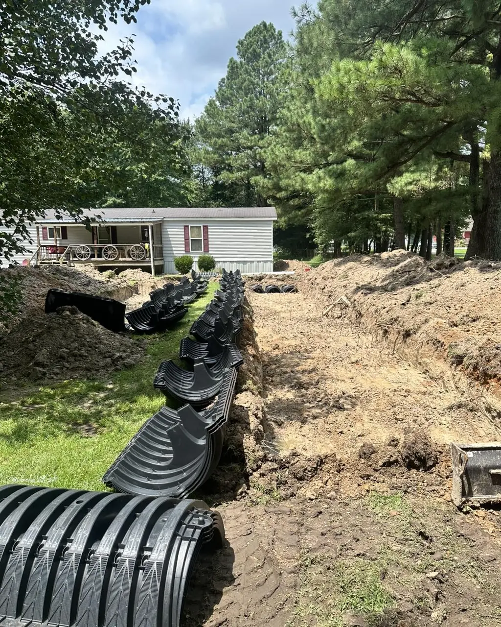 Drain field chambers going into a trench beside a home